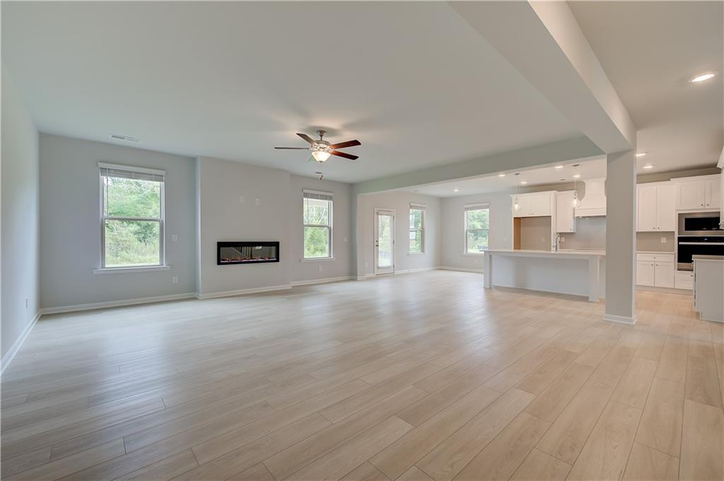 343 Linford Drive Locust Grove, GA 30248 - Photo 17 of 36 an empty room with windows and fireplace