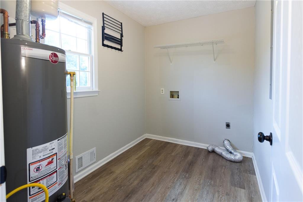 374 McGiboney Road Covington, GA 30016 - Photo 26 of 29 a room with wooden floor and couch