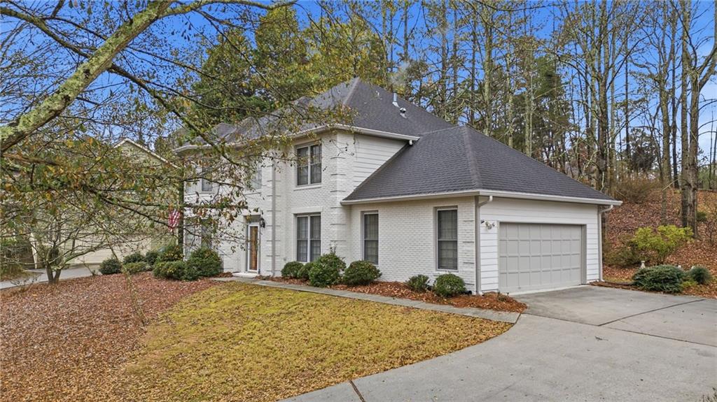 5868 Valine Way Sugar Hill, GA 30518 - Photo 2 of 32 a front view of house with yard and trees