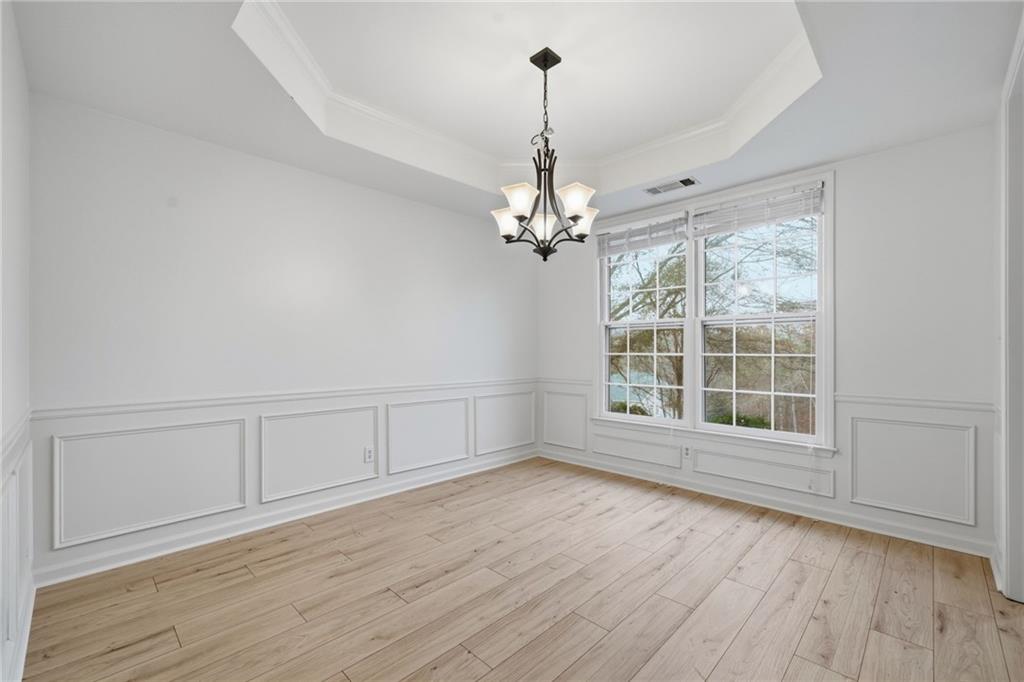 5868 Valine Way Sugar Hill, GA 30518 - Photo 5 of 32 a view of wooden floor and windows in a room