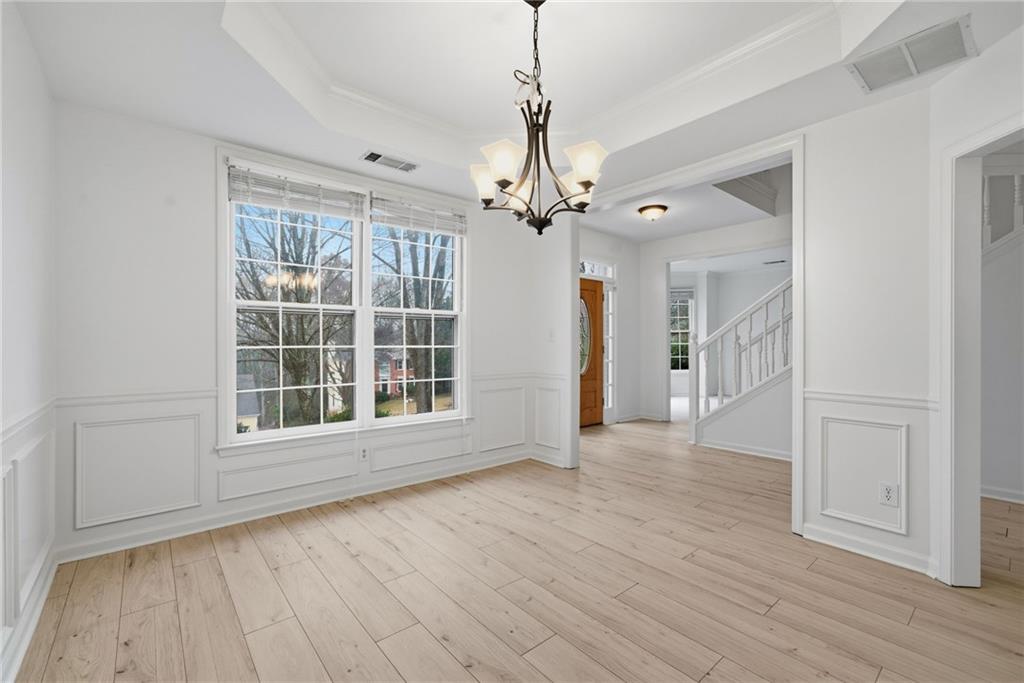 5868 Valine Way Sugar Hill, GA 30518 - Photo 6 of 32 a view of an empty room with wooden floor fireplace and a window