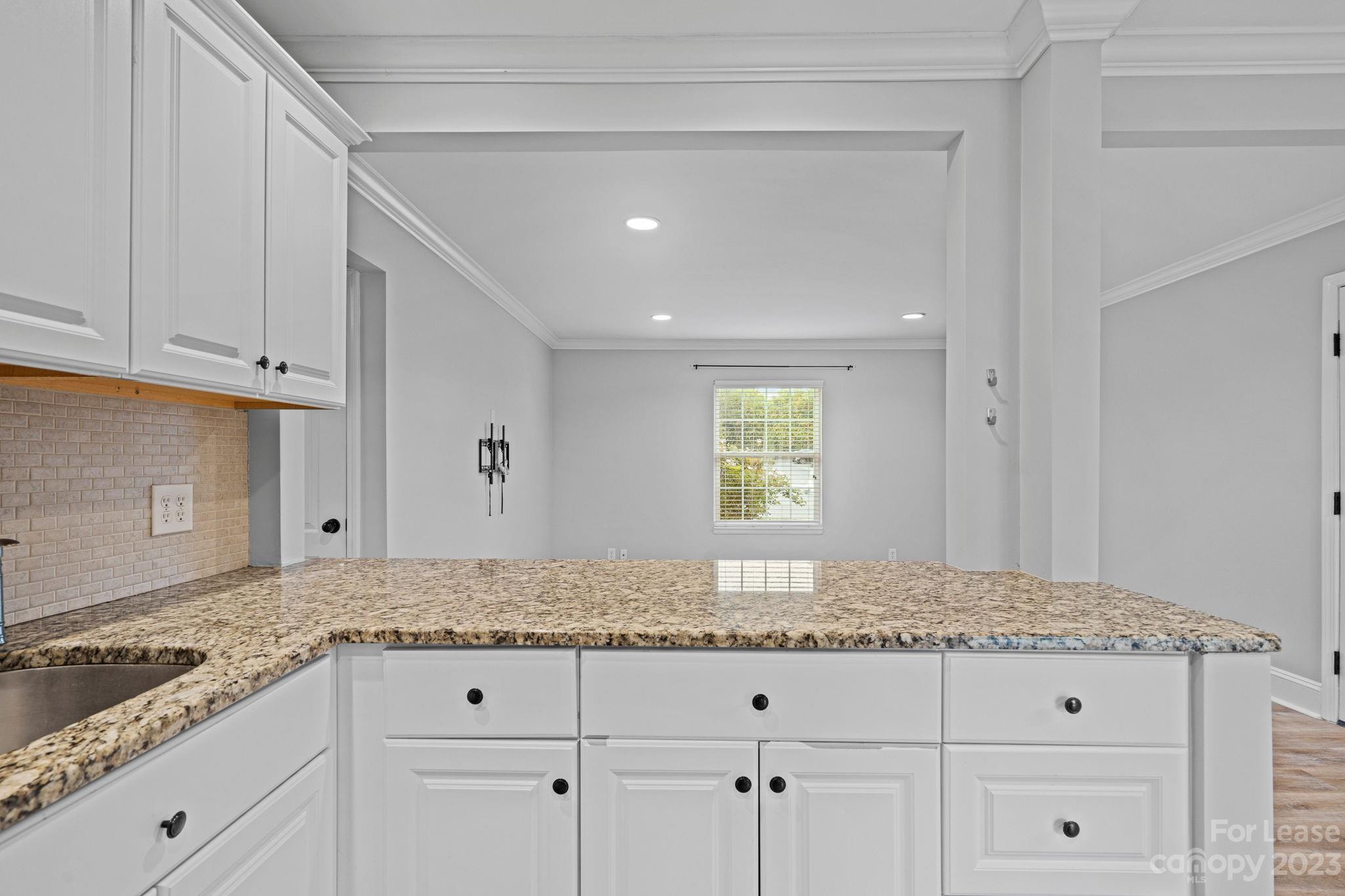 a kitchen with granite countertop white cabinets and a granite counter tops