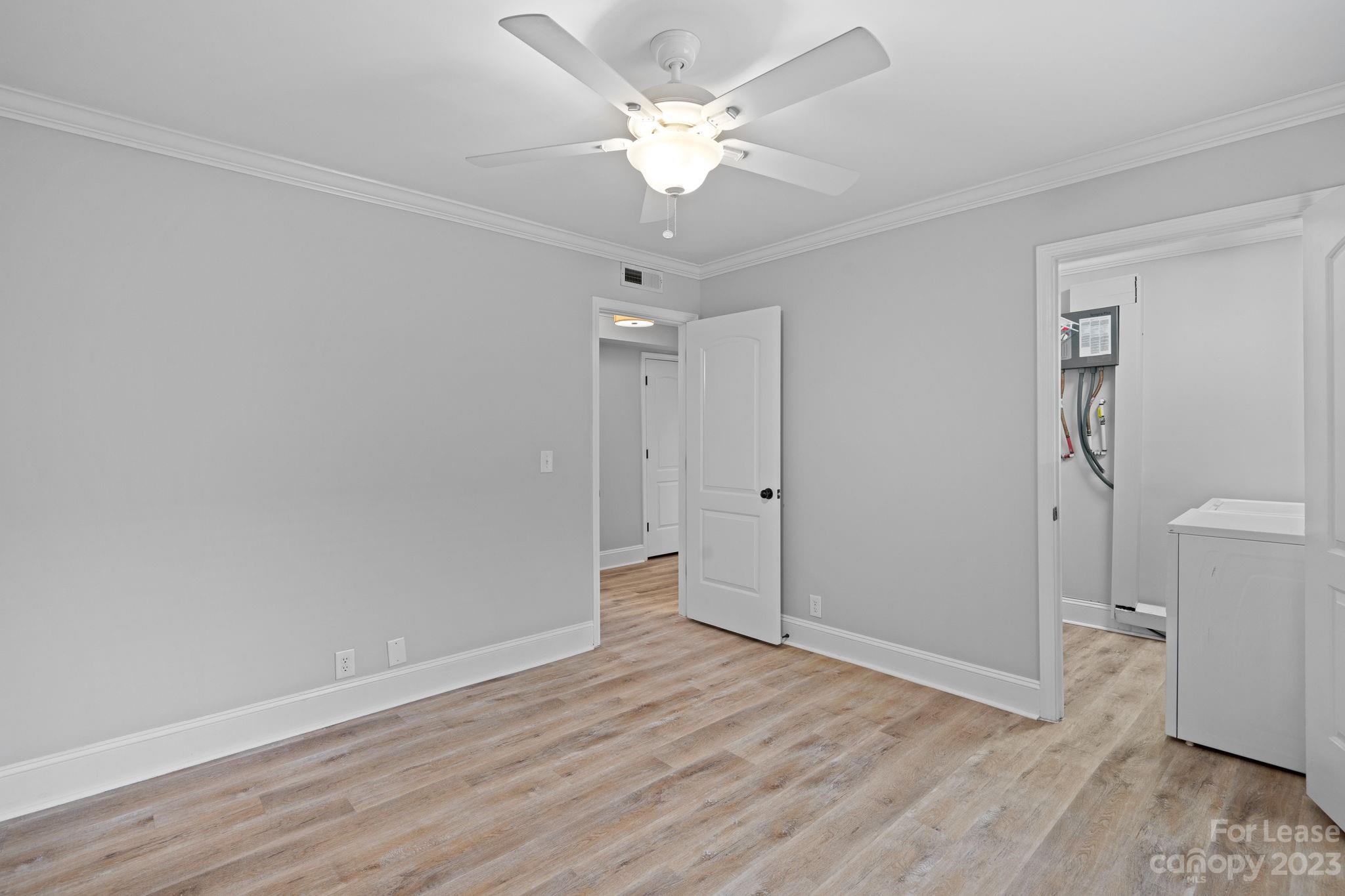 2614 Park Road Charlotte, NC 28209 - Photo 12 of 19 an empty room with wooden floor and a ceiling fan