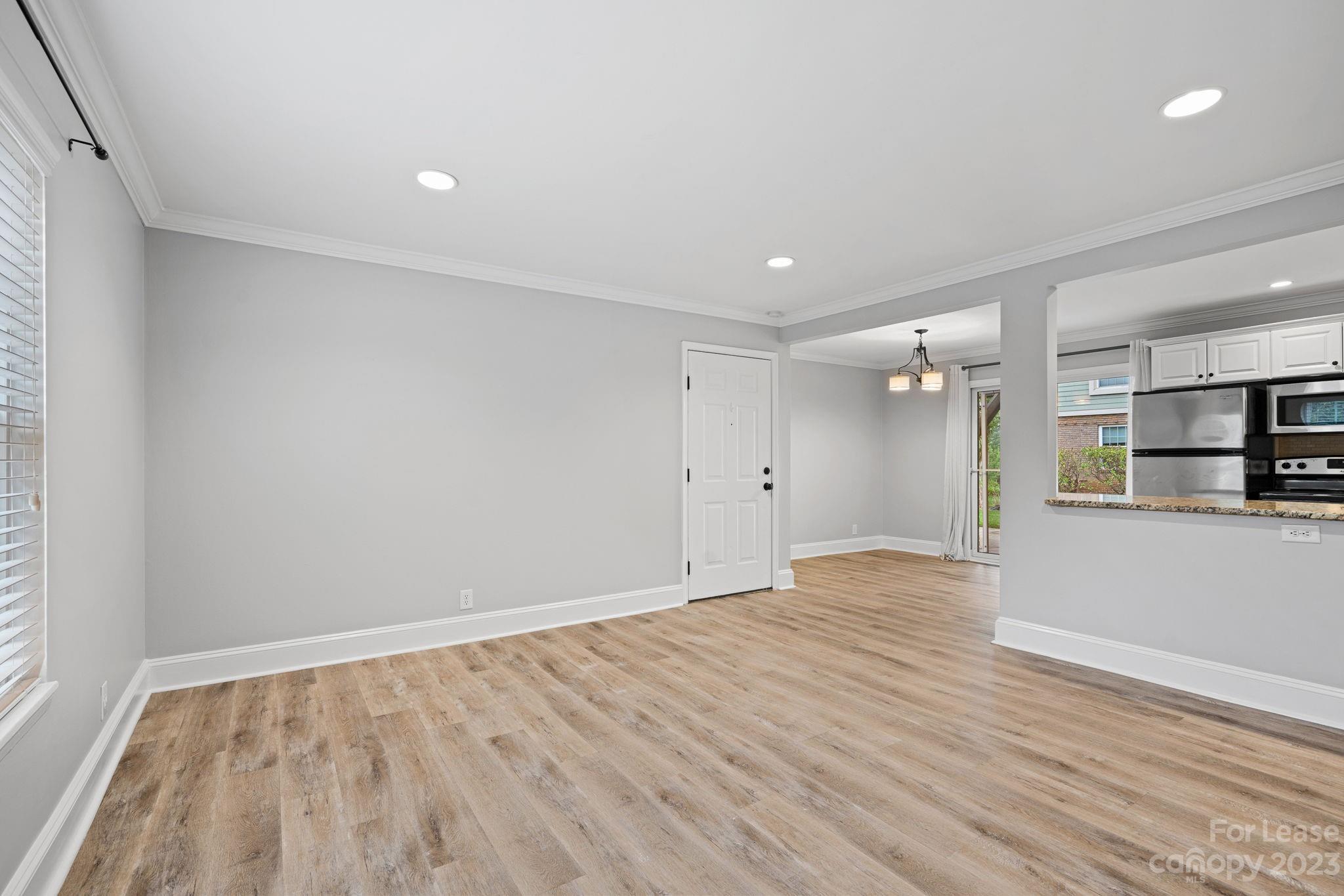 2614 Park Road Charlotte, NC 28209 - Photo 2 of 19 a view of an empty room with wooden floor and a window