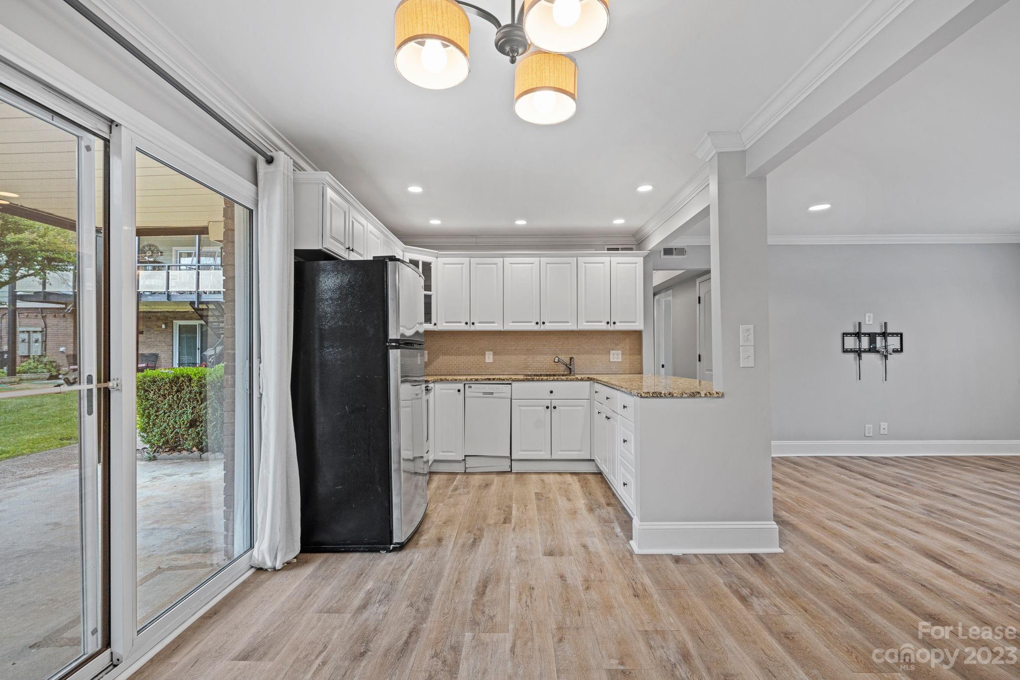 2614 Park Road Charlotte, NC 28209 - Photo 3 of 19 a kitchen with a refrigerator a stove and wooden floor