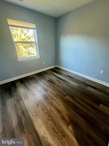 a view of an empty room and wooden floor