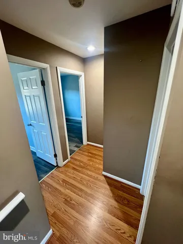 a front view of a house with cars parked