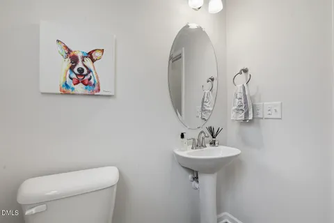 a living room with dining table and a flat screen tv