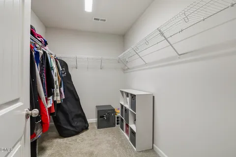 a spacious bedroom with a large bed and a flat screen tv