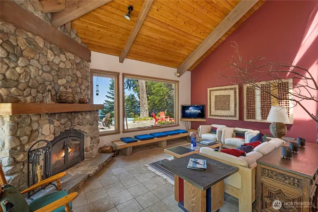 a living room with furniture a fireplace and a table