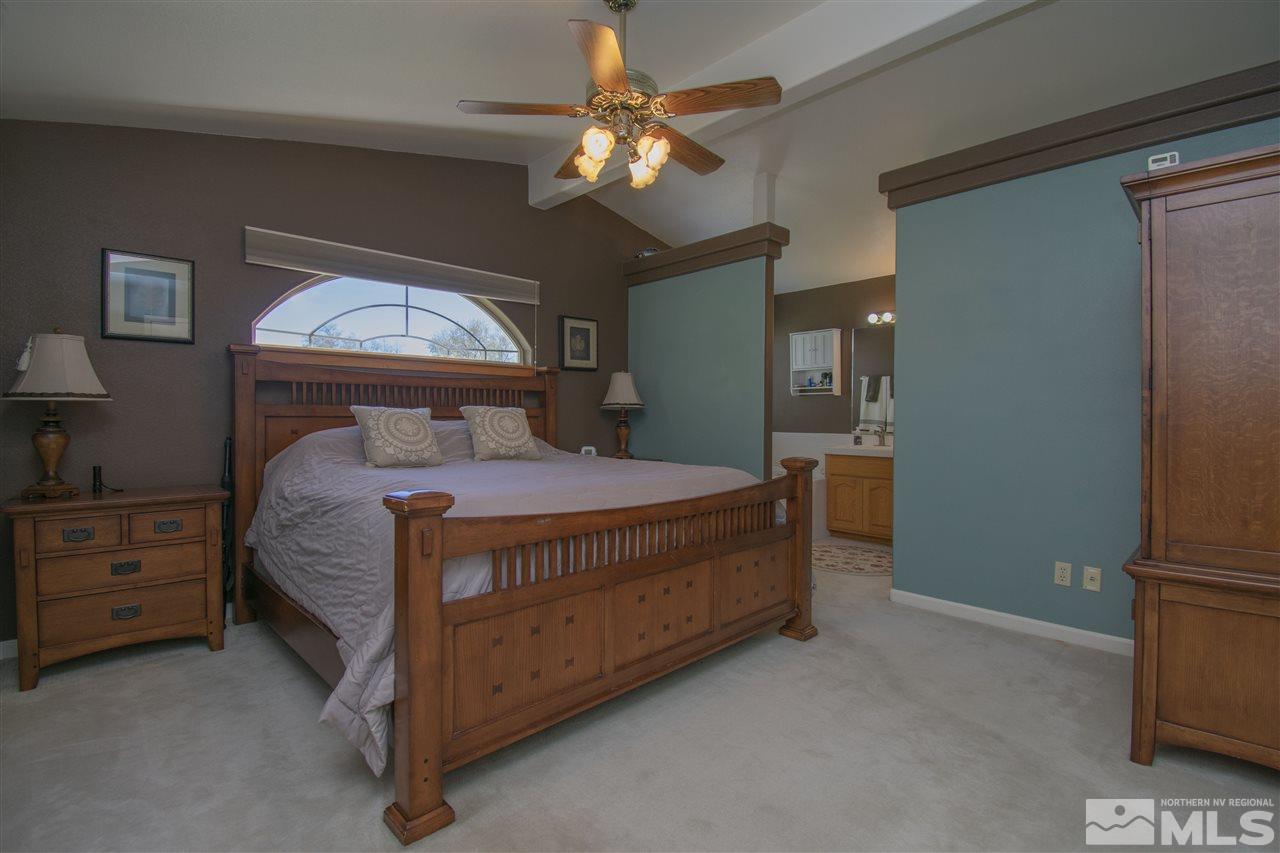 5141 Solias Road Fallon, NV 89406 - Photo 11 of 24 a bedroom with a bed and a chandelier