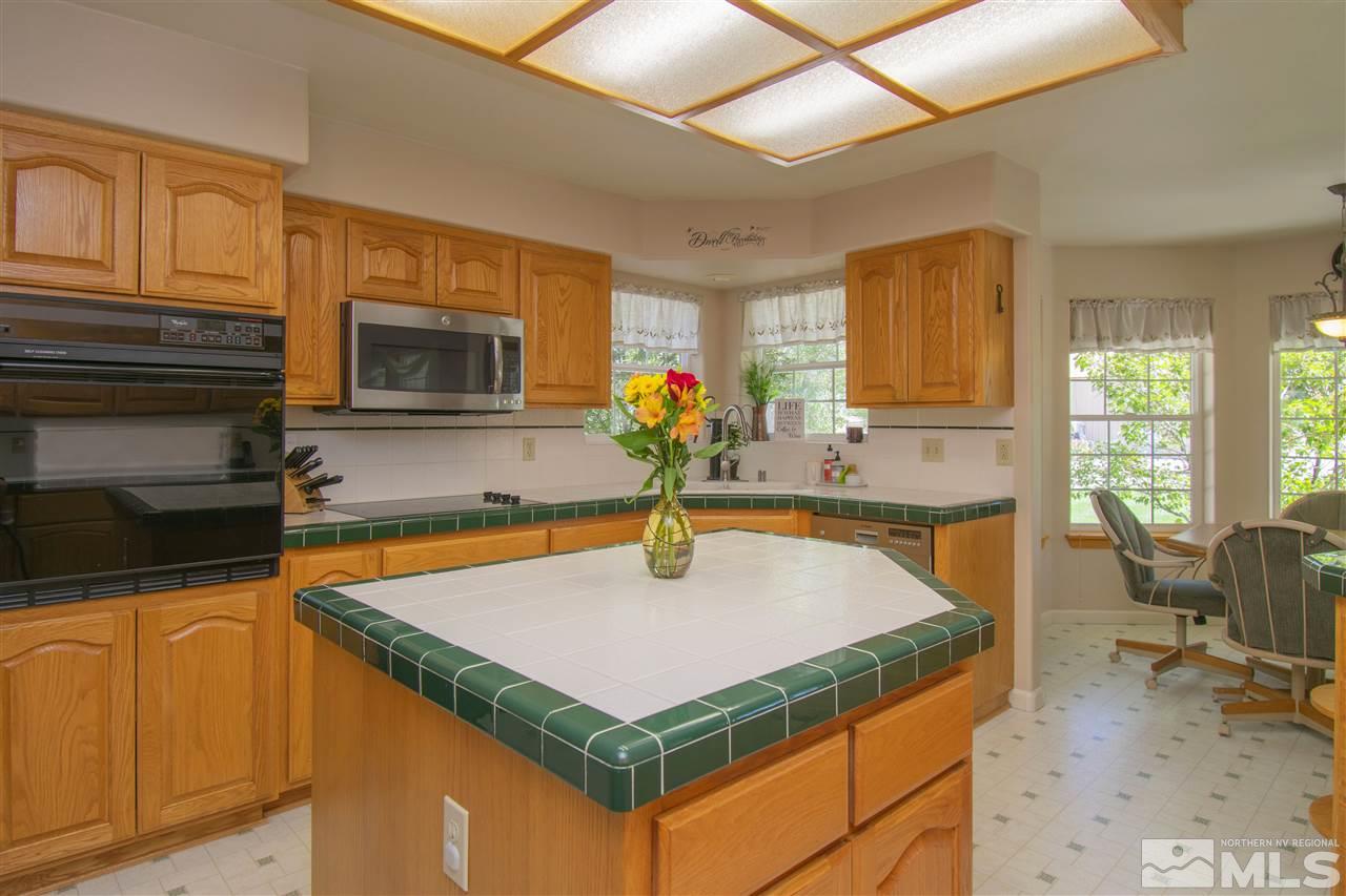 5141 Solias Road Fallon, NV 89406 - Photo 4 of 24 a kitchen with stainless steel appliances a sink a microwave cabinets and a dining table