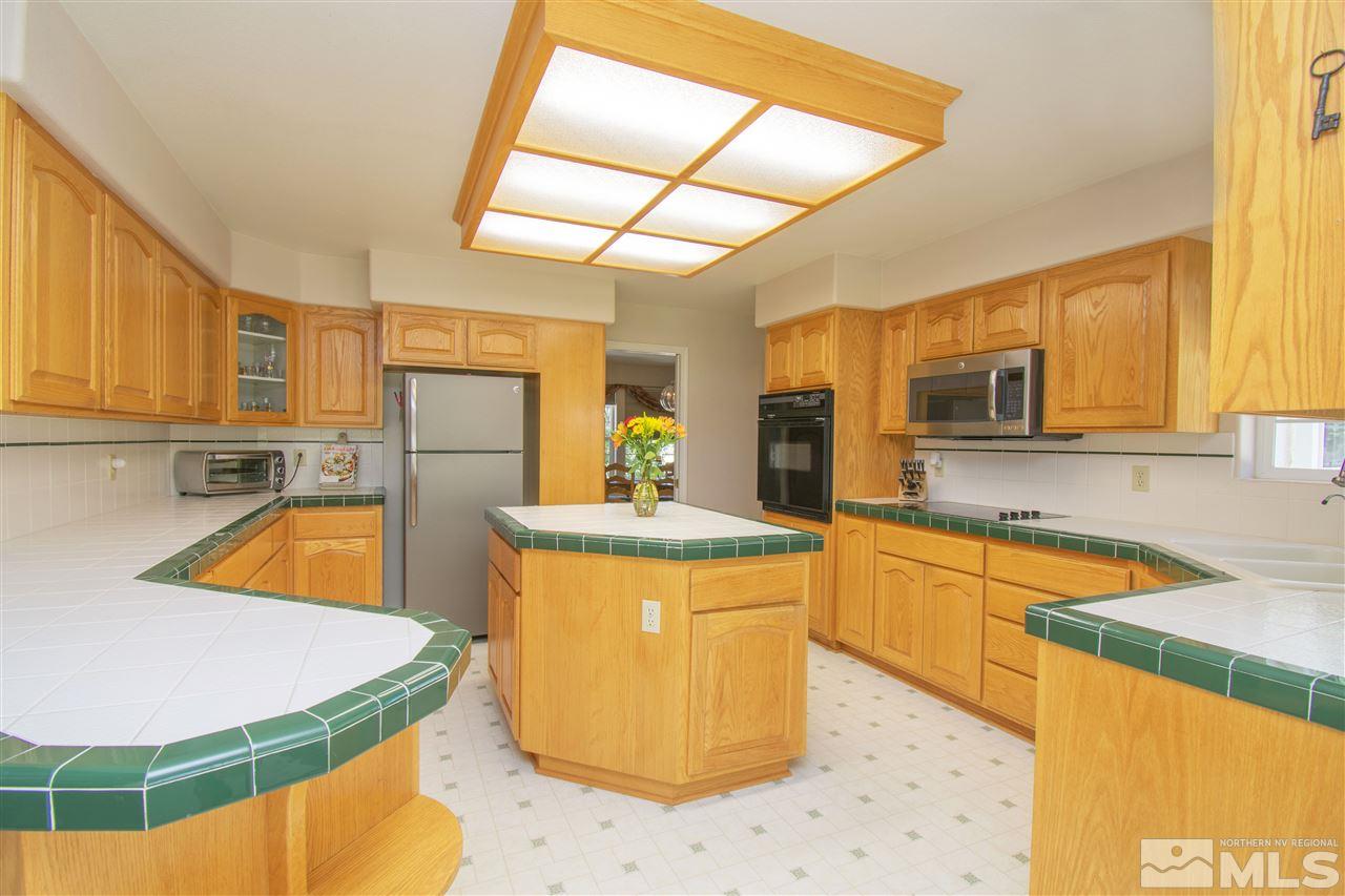 5141 Solias Road Fallon, NV 89406 - Photo 5 of 24 a kitchen with stainless steel appliances kitchen island granite countertop a sink and cabinets