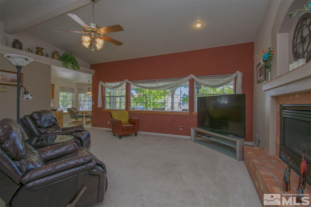 5141 Solias Road Fallon, NV 89406 - Photo 8 of 24 a living room with furniture a flat screen tv and a fireplace