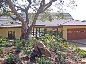 a front view of a house with garden