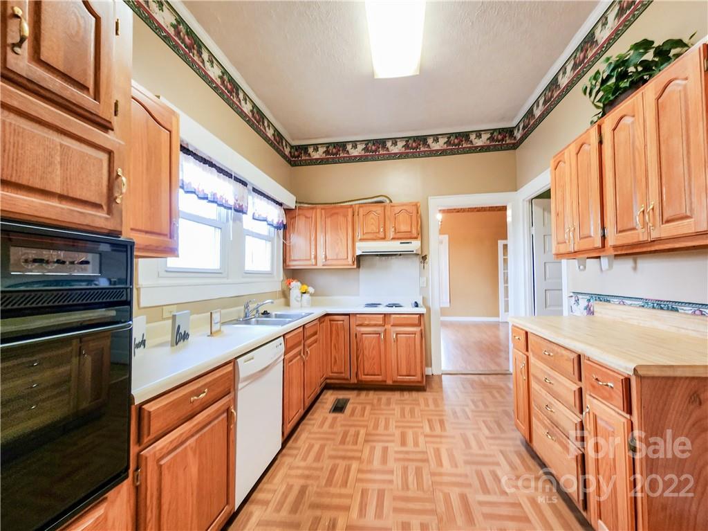 199 North Meridian Street Rutherfordton, NC 28139 - Photo 16 of 39 a kitchen with stainless steel appliances granite countertop a sink and cabinets