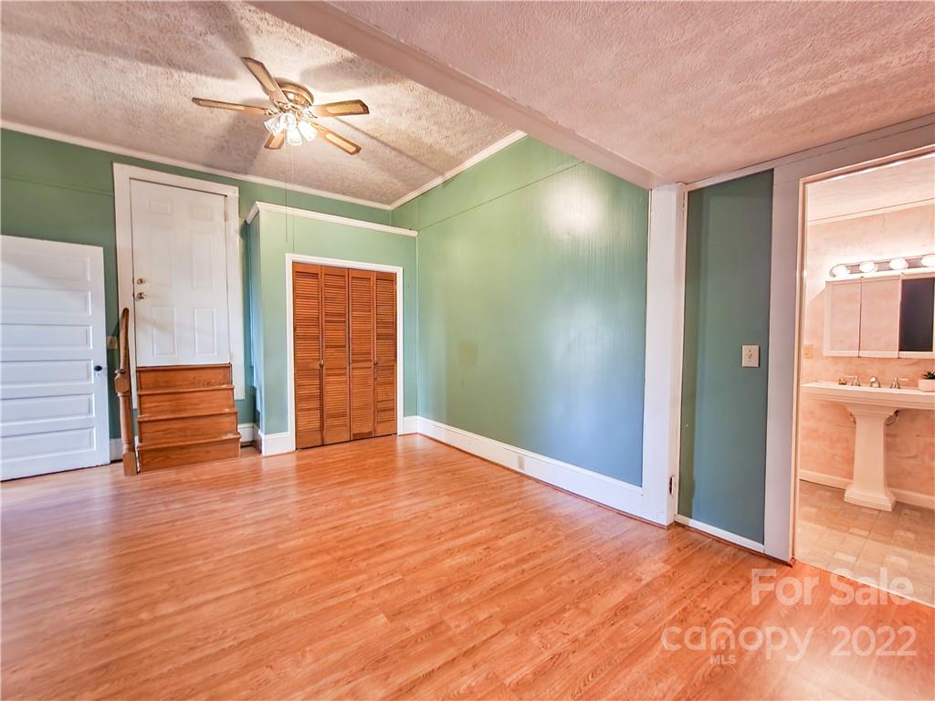 199 North Meridian Street Rutherfordton, NC 28139 - Photo 21 of 39 a view of an empty room with window and wooden floor