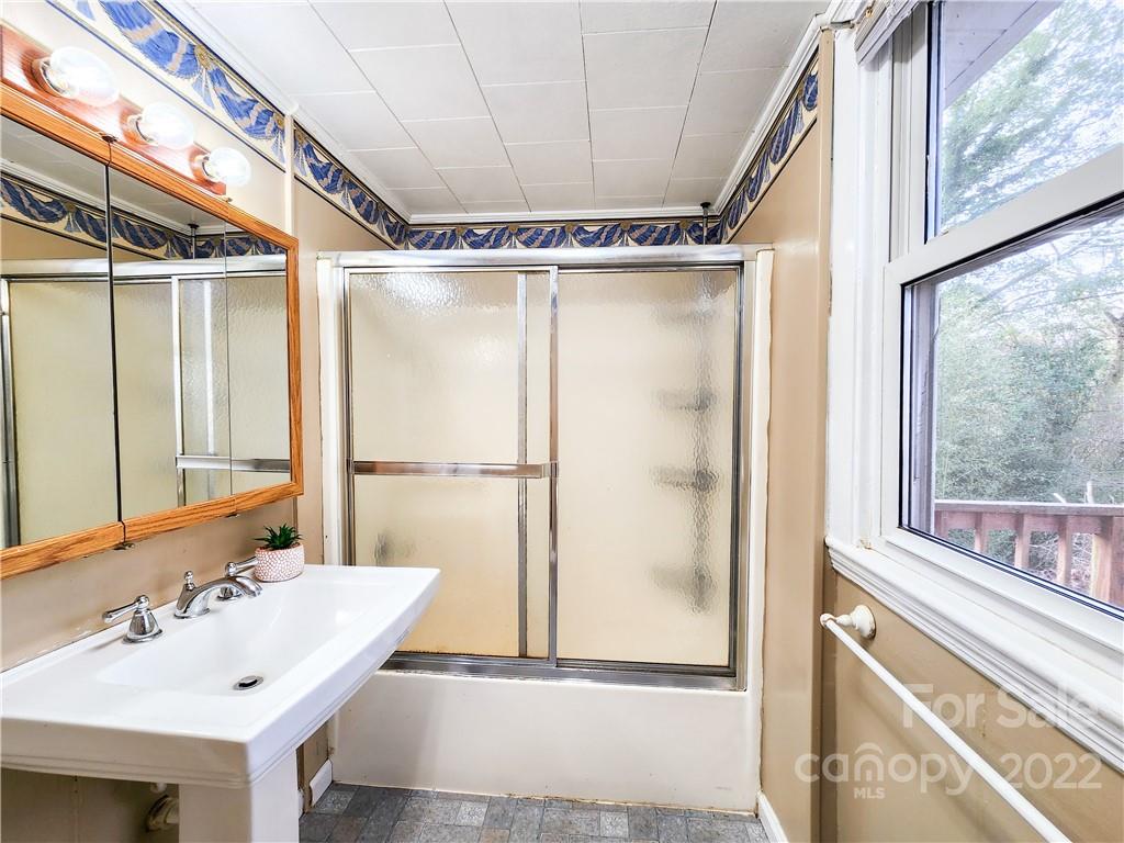 199 North Meridian Street Rutherfordton, NC 28139 - Photo 25 of 39 a bathroom with a sink and a mirror