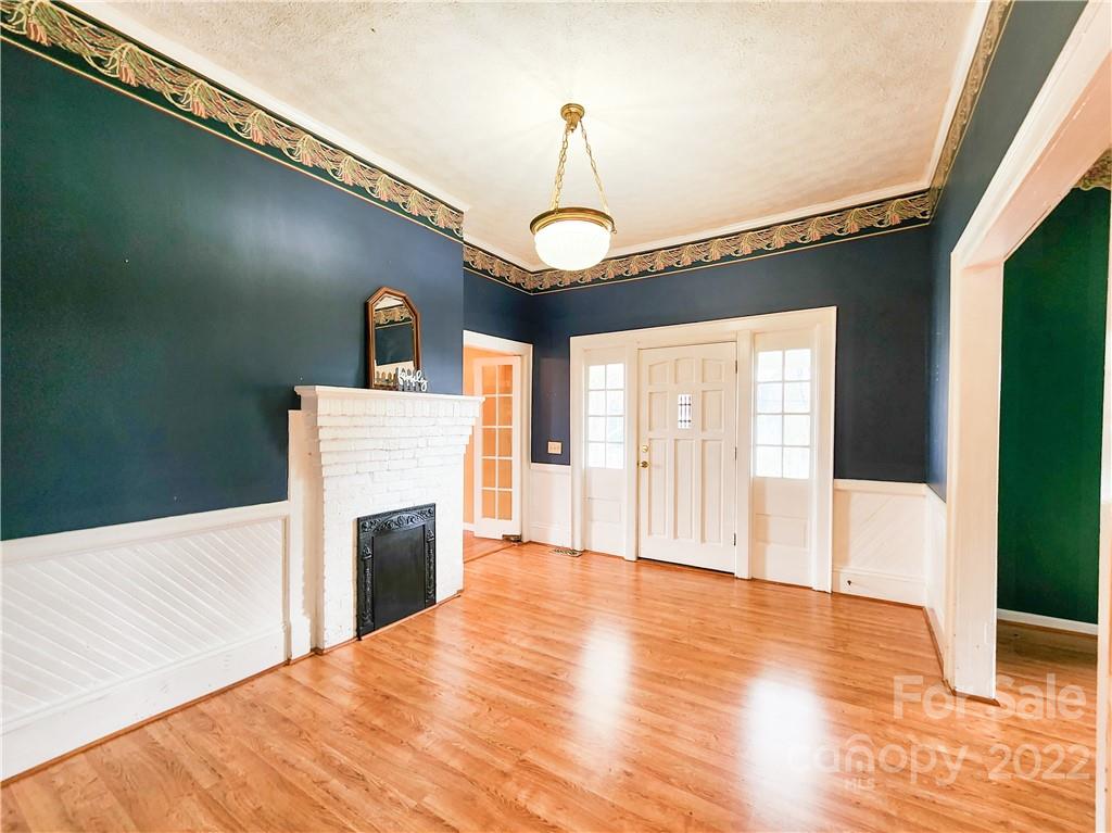 199 North Meridian Street Rutherfordton, NC 28139 - Photo 5 of 39 a view of a livingroom with a fireplace wooden floor and staircase