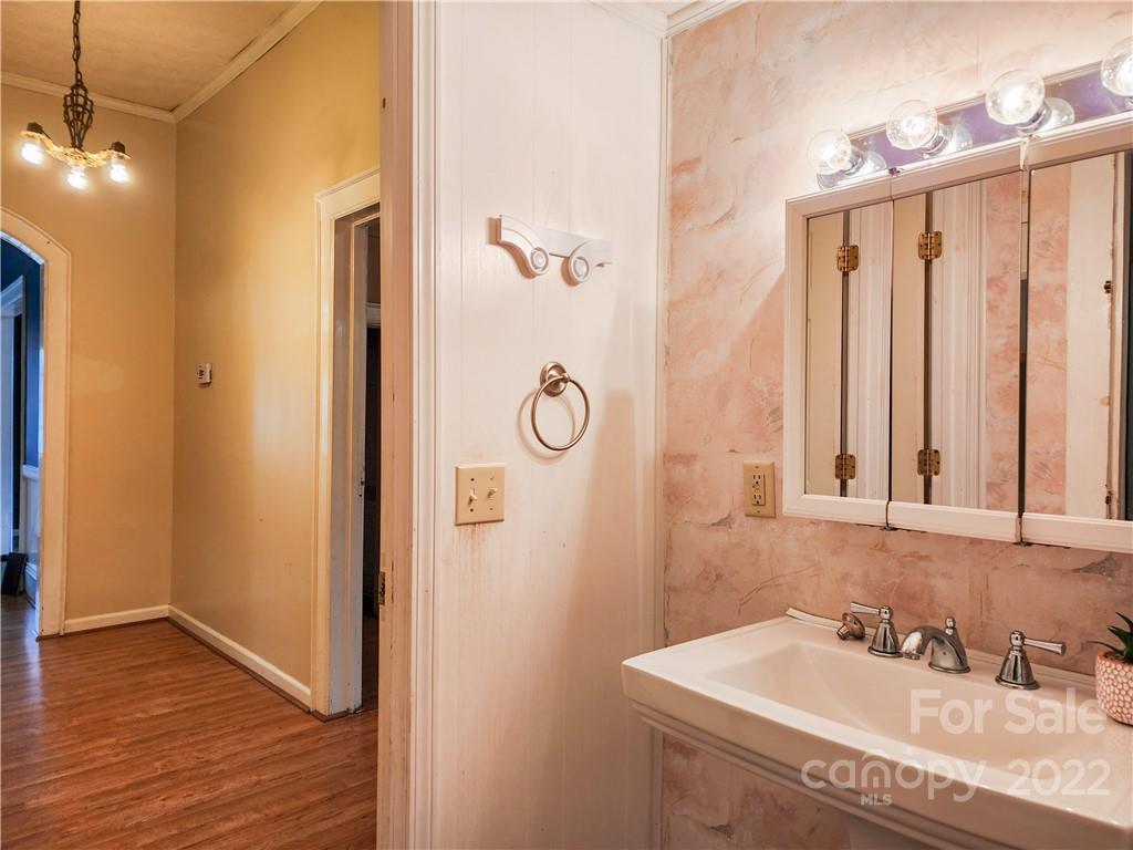 199 North Meridian Street Rutherfordton, NC 28139 - Photo 10 of 39 a bathroom with a granite countertop sink a mirror and shower