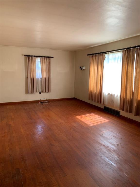 861 Franklin Road Slippery Rock, PA 16057 - Photo 3 of 9 an empty room with wooden floor and windows