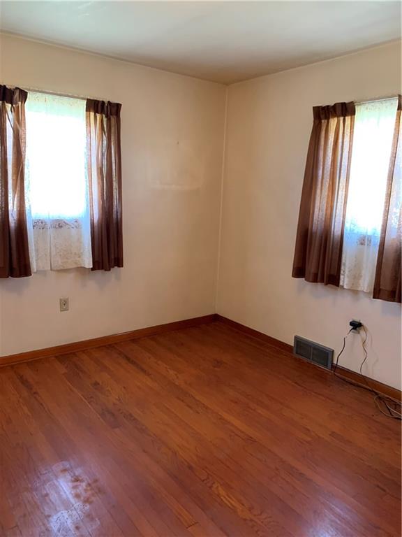 861 Franklin Road Slippery Rock, PA 16057 - Photo 4 of 9 a view of an empty room with wooden floor and a window