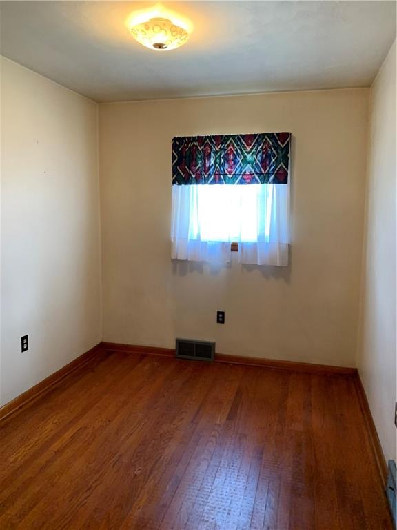 861 Franklin Road Slippery Rock, PA 16057 - Photo 5 of 9 an empty room with wooden floor and window