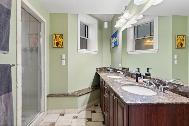 a bathroom with a granite countertop sink and a mirror