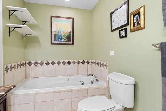 a bathroom with a toilet and a bathtub