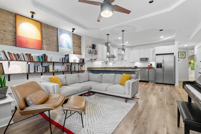 a living room with stainless steel appliances kitchen island granite countertop furniture and a kitchen view