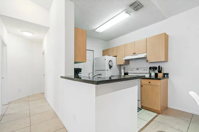 a kitchen with stainless steel appliances granite countertop a sink and cabinets