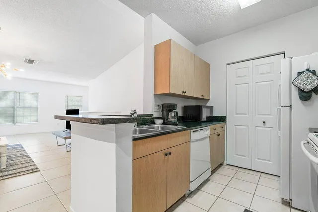 a kitchen with stainless steel appliances granite countertop a sink and cabinets