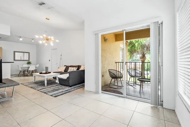 a living room with furniture and a large window