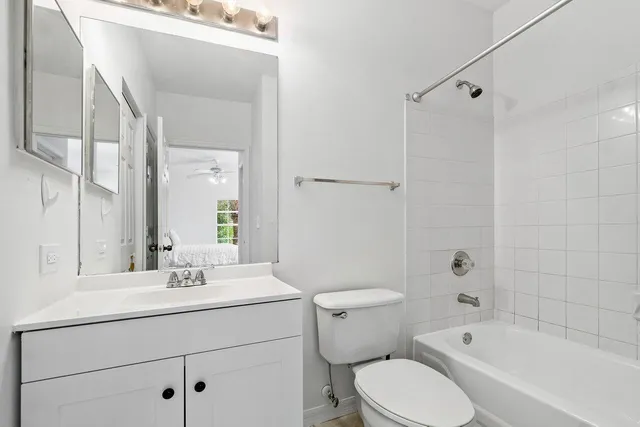 a bathroom with a sink mirror vanity and toilet