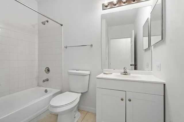 a bathroom with a sink toilet a bathtub and vanity