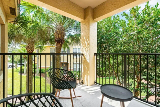 a view of a chairs and table in the balcony