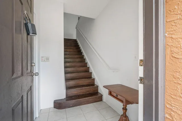 a view of entryway and hall with wooden floor
