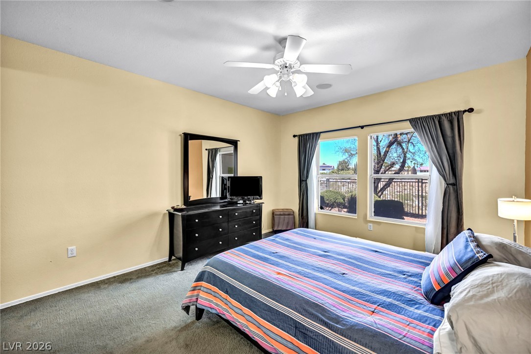 10730 Amber Ridge Drive, Unit 101 Las Vegas, NV 89144 - Photo 20 of 32 A quiet retreat, this bedroom offers comfort and a well-lit space for relaxation.