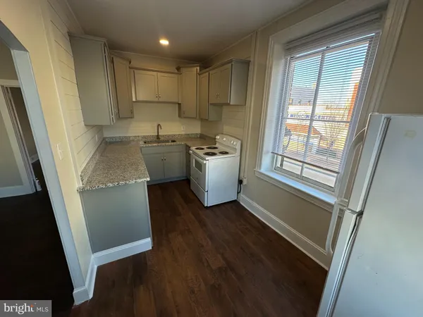 a kitchen with a refrigerator and a sink