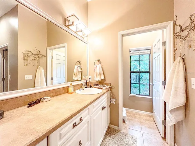 a spacious bathroom with a double vanity sink and a mirror