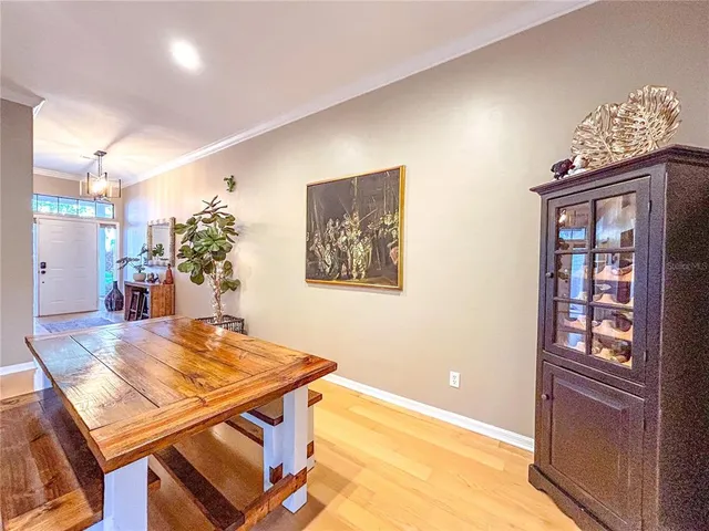 a view of a dining room with furniture and chandelier