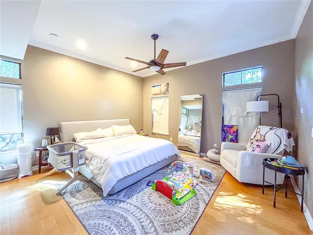 a bedroom with a bed mirror and a window