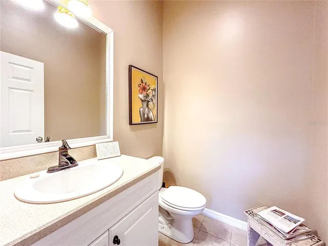 a bathroom with a white toilet sink and a mirror