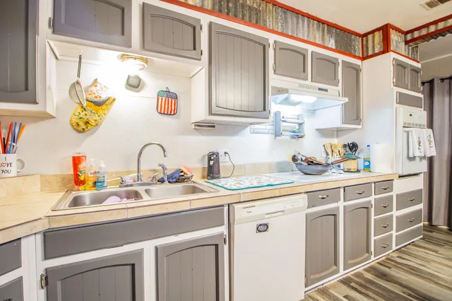 a kitchen with stainless steel appliances cabinets a sink and a window