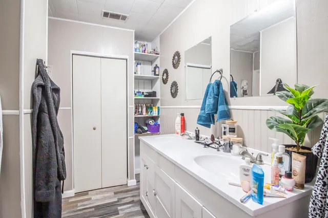 a bathroom with sink a mirror and shower