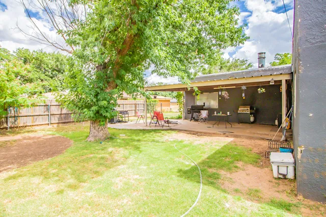a view of a backyard with a patio and garden
