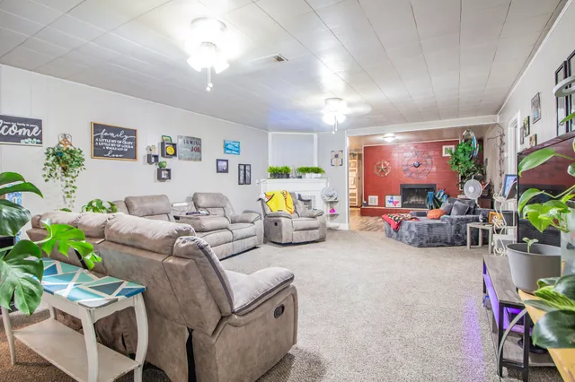 a living room with furniture and a chandelier