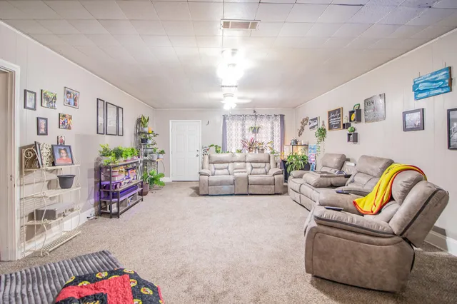 a bed room with furniture and a book shelf