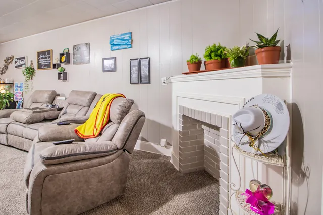 a living room with furniture and flowers