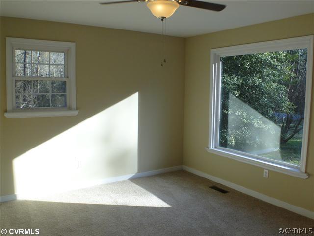 235 Wakema Road West Point, VA 23181 - Photo 2 of 9 a view of an empty room with windows